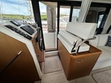 A beautiful dual helm position/seat with side door access to side deck which has easy access for easy docking